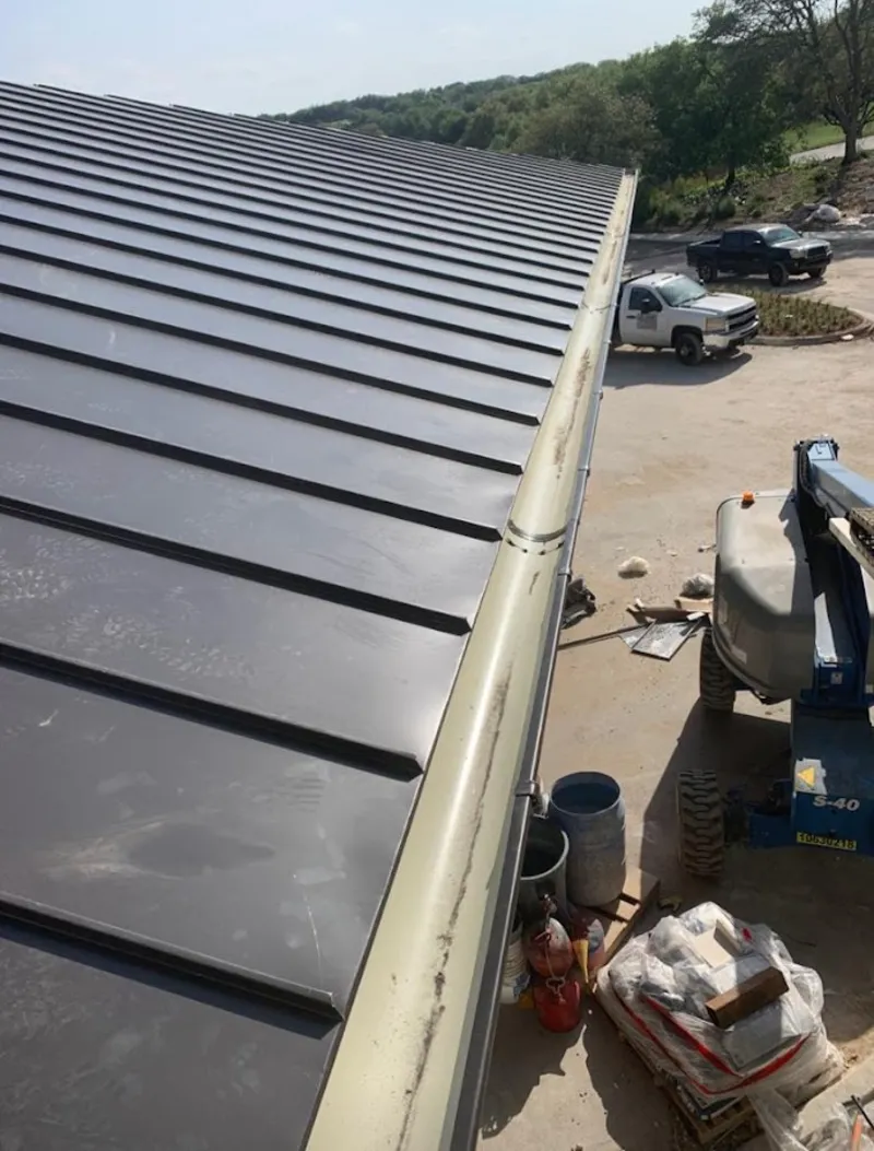 Standing seam panel and gutter detail on a metal roofing jobsite in Clarksburg